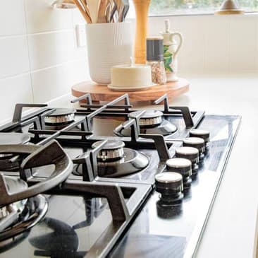 A gas cooktop with the burners lit