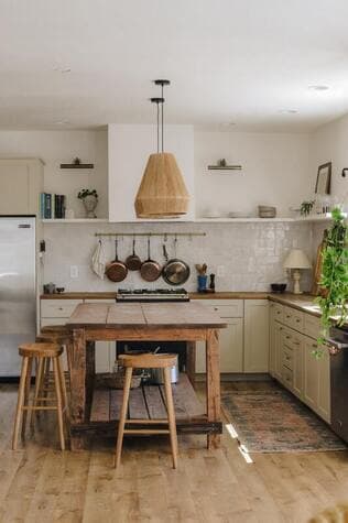 A bright renovated kitchen with a wood island